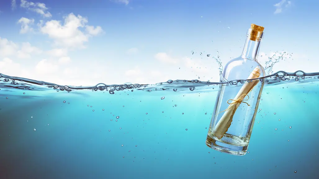 Message in a bottle, floating in the sea. Illustration: Shutterstock