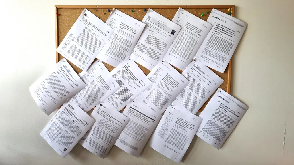 Bulletin board with 15 front pages of scientific publications.