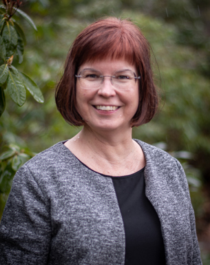 Portrait photo of a woman outdoors.