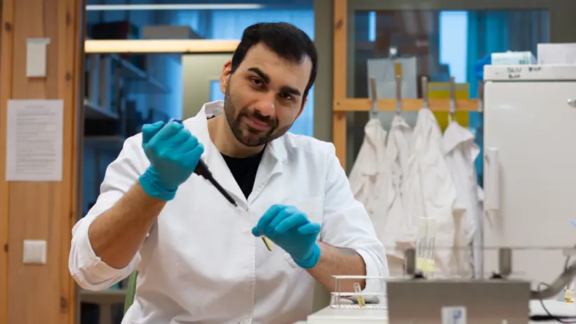 Picture of Homayoon Davam working seated in the laboratory at SLU.