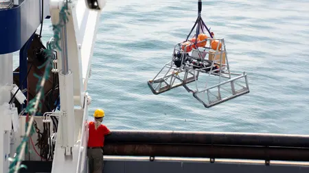 Rig suspended on a wire from the vessel’s deck