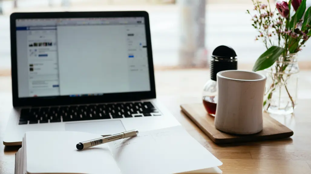 Laptop and notebook on table