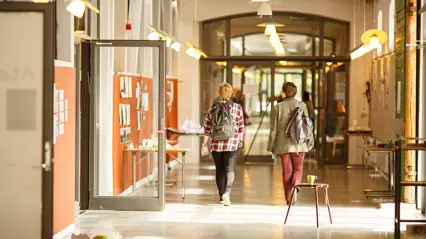 Two students in a corridor